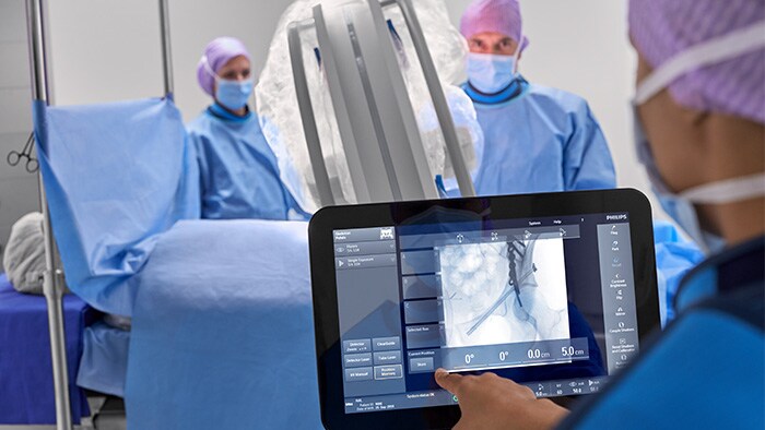 Orthopedic surgeon using touchscreen during surgery